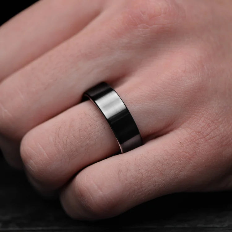 Mens Black Titanium Wedding Band with Brushed Finish and Moss Agate Inner Sleeve, 8mm, shown on hand, unique mens ring with free engraving option.