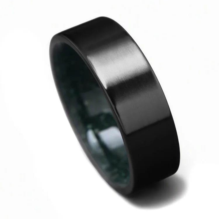 Black titanium wedding band with brushed finish and moss agate inner sleeve, 8mm mens ring, unique design, free engraving option, displayed on a white background.