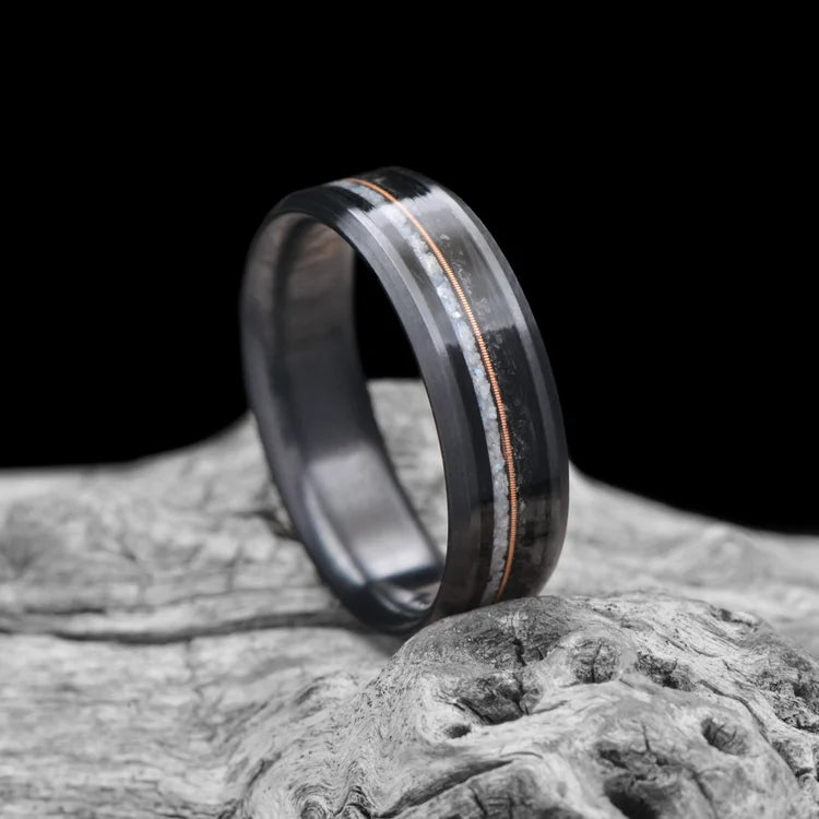 Black Titanium Wedding Band with Pearl & Black Onyx Inlays, 7mm Men's Wedding Ring, Beveled Profile, Polished Finish, Free Engraving, displayed on white sea branch.