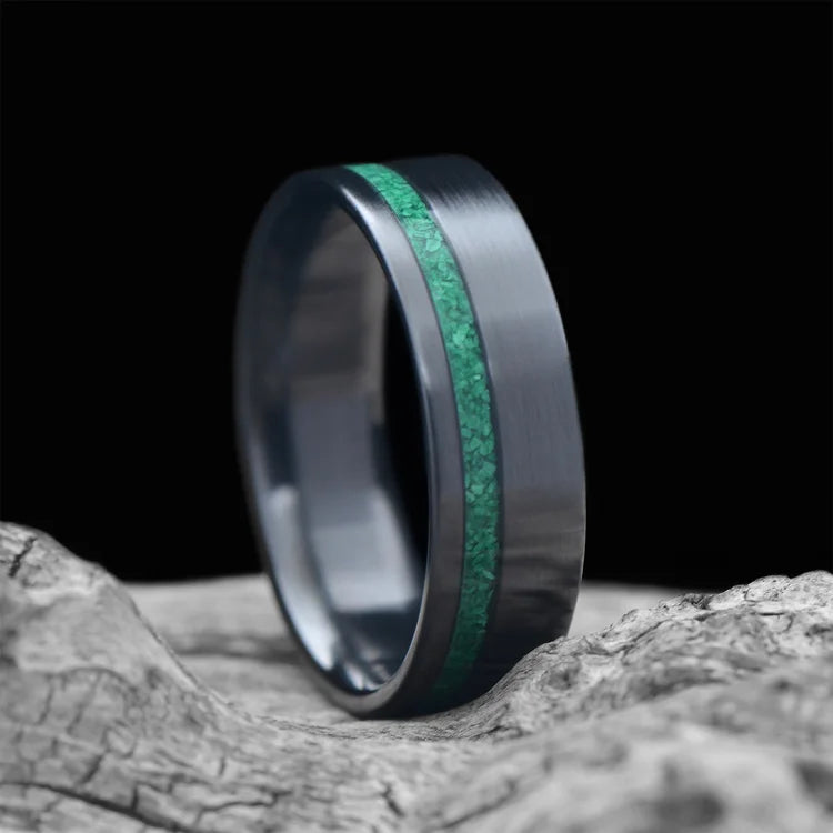 Zirconium wedding band with malachite inlay, 7mm men's ring, brushed flat profile, unique design, free engraving, displayed on white sea branch.