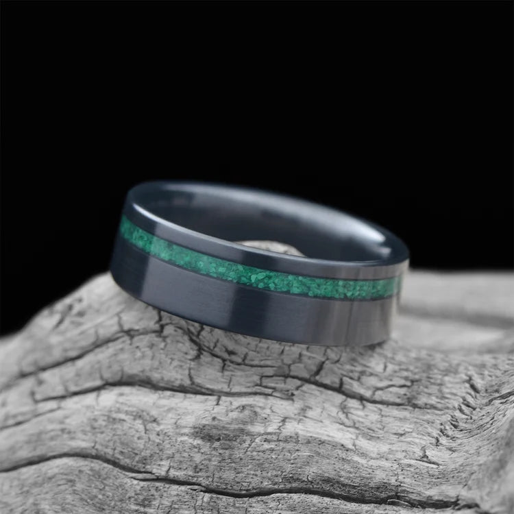 Zirconium wedding band with malachite inlay, 7mm men's ring, brushed flat profile, unique design, free engraving, displayed on white sea branch.