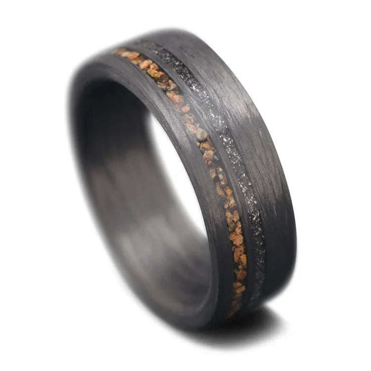 Unidirectional mens wedding ring with crushed T-Rex and meteorite inlays, 7mm width, unique design, free engraving, on white background.