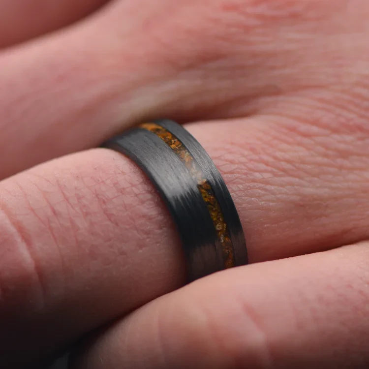 Unidirectional wedding band with tigers eye inlay on a hand, showcasing the 8mm matte finish mens ring with free engraving, unique design.