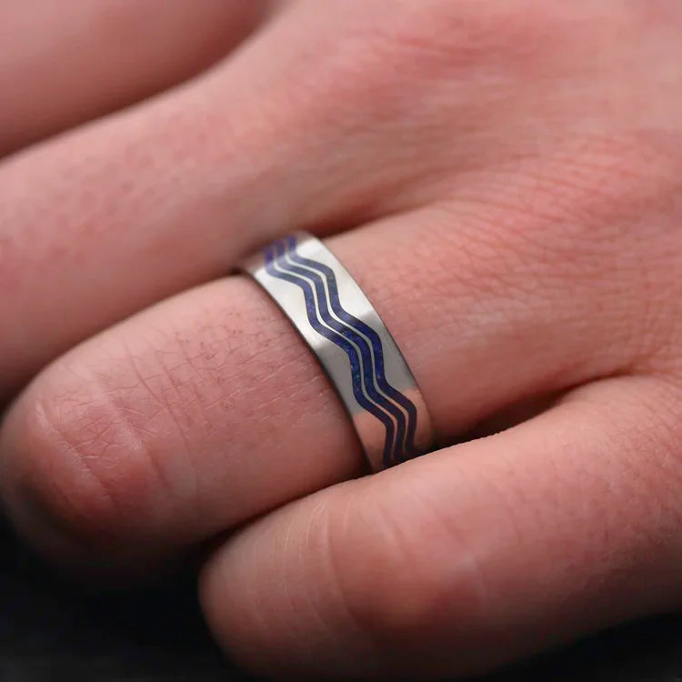 Mens titanium wedding band with lapis lazuli inlay, 7mm width, featuring free engraving, unique custom design, worn on a hand.
