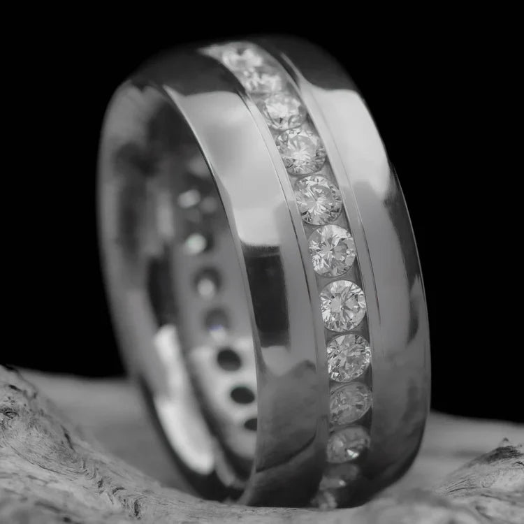 Titanium wedding band with eternity set precious stone, 8mm mens ring with polished domed profile, free engraving, displayed on a white sea branch.