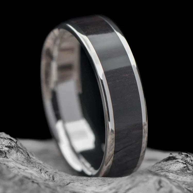 Titanium ring with Central African Blackwood inlay, 6mm mens wedding band, unique custom design, free engraving, displayed on white sea branch.