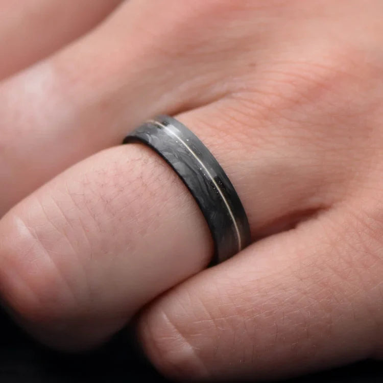 Mens 6mm matte flat profile forged wedding band featuring meteorite and guitar string inlay, with a bloodwood inner sleeve, shown on a hand; includes free engraving.