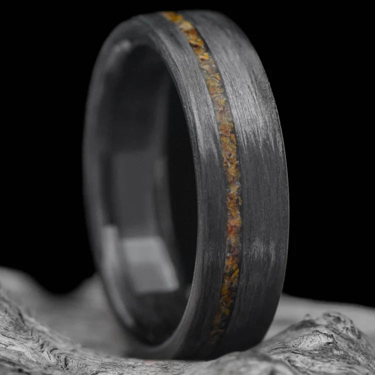 Unidirectional wedding band with tigers eye and central inlay, 6mm mens matte flat profile ring, unique custom design, free engraving, displayed on a white sea branch.
