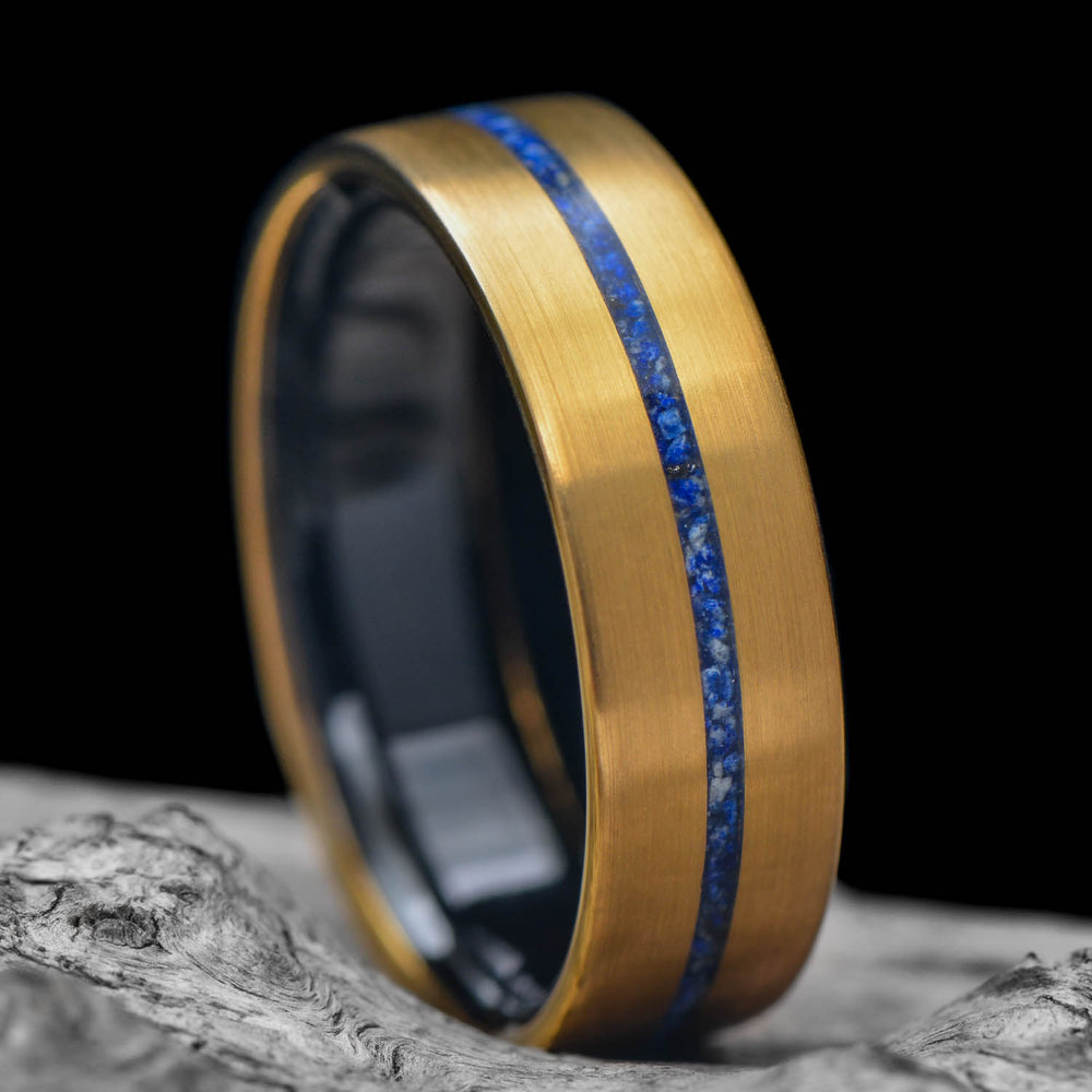 Gold custom wedding band with a black interior and a thin blue stone inlay stripe, one of the Sesto Synergy design paths.
