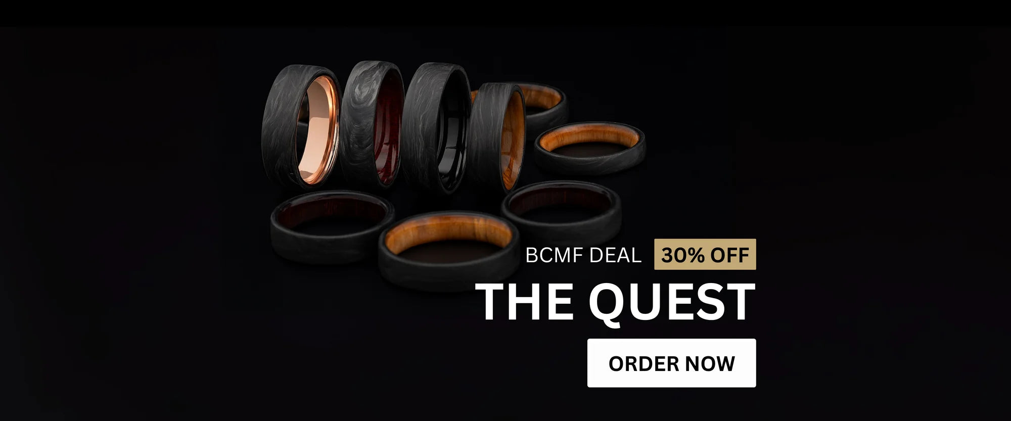 Display of forged carbon wedding rings from The Quest collection featuring copper and wood interiors, shown with a 30% off Black Friday deal.