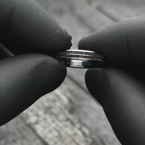 Black Titanium Wedding Band with Meteorite Inlay, 4mm, showcased with black gloves, unique custom simple ring, free engraving option, perfect for weddings.