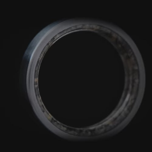 Black titanium wedding ring with dinosaur bone inner sleeve, 5mm custom band, unique simple design, free engraving option.