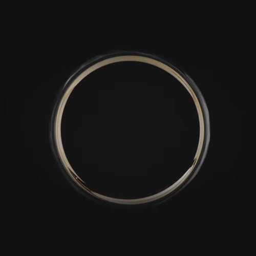 Black titanium wedding band with 14K yellow gold inner sleeve, featuring a faceted domed profile, 6mm width, mens wedding ring, unique design, free engraving available.